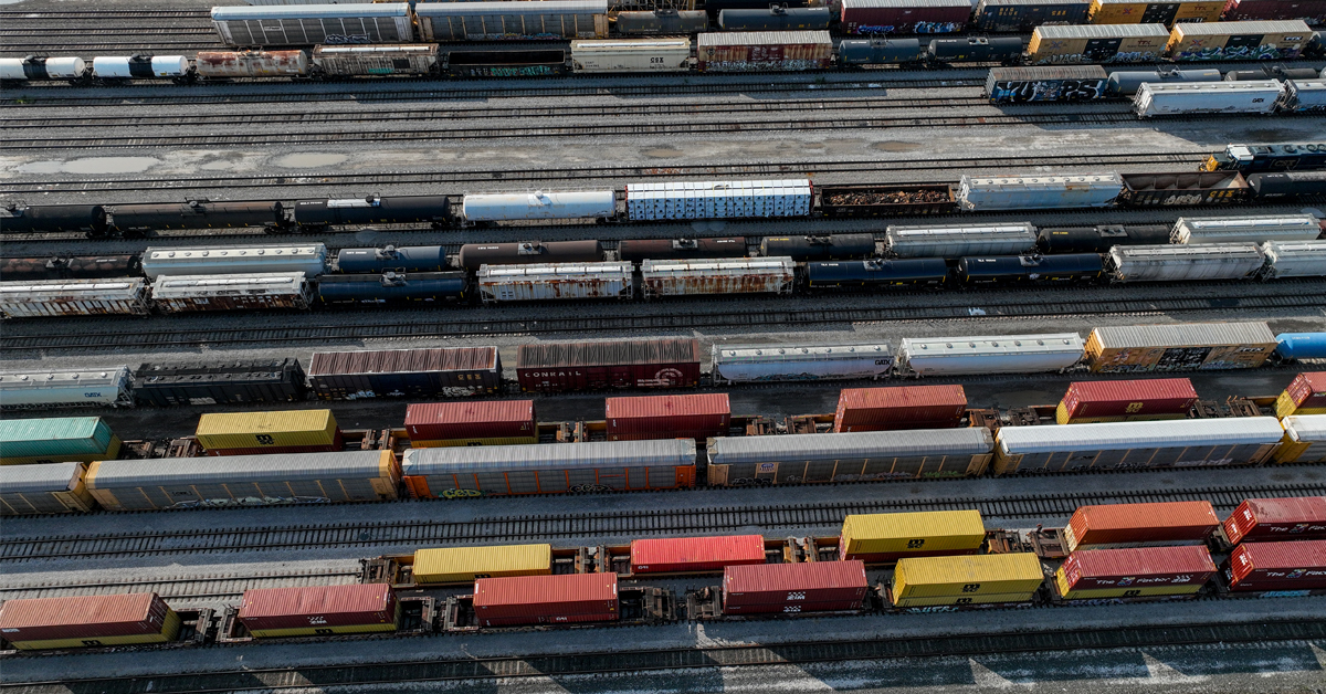 Lines of colorful railcars in a rail yard.